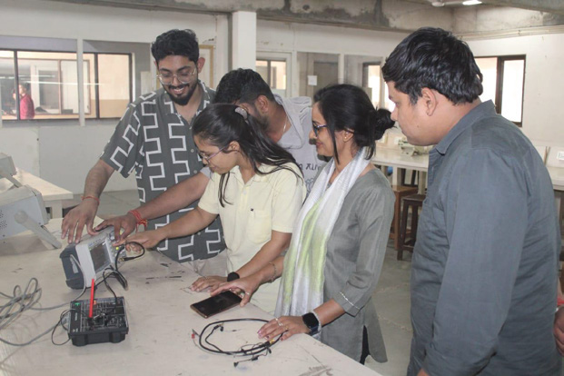Students developing an electronics project with faculty mentorship