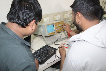 Students testing an electronic circuit